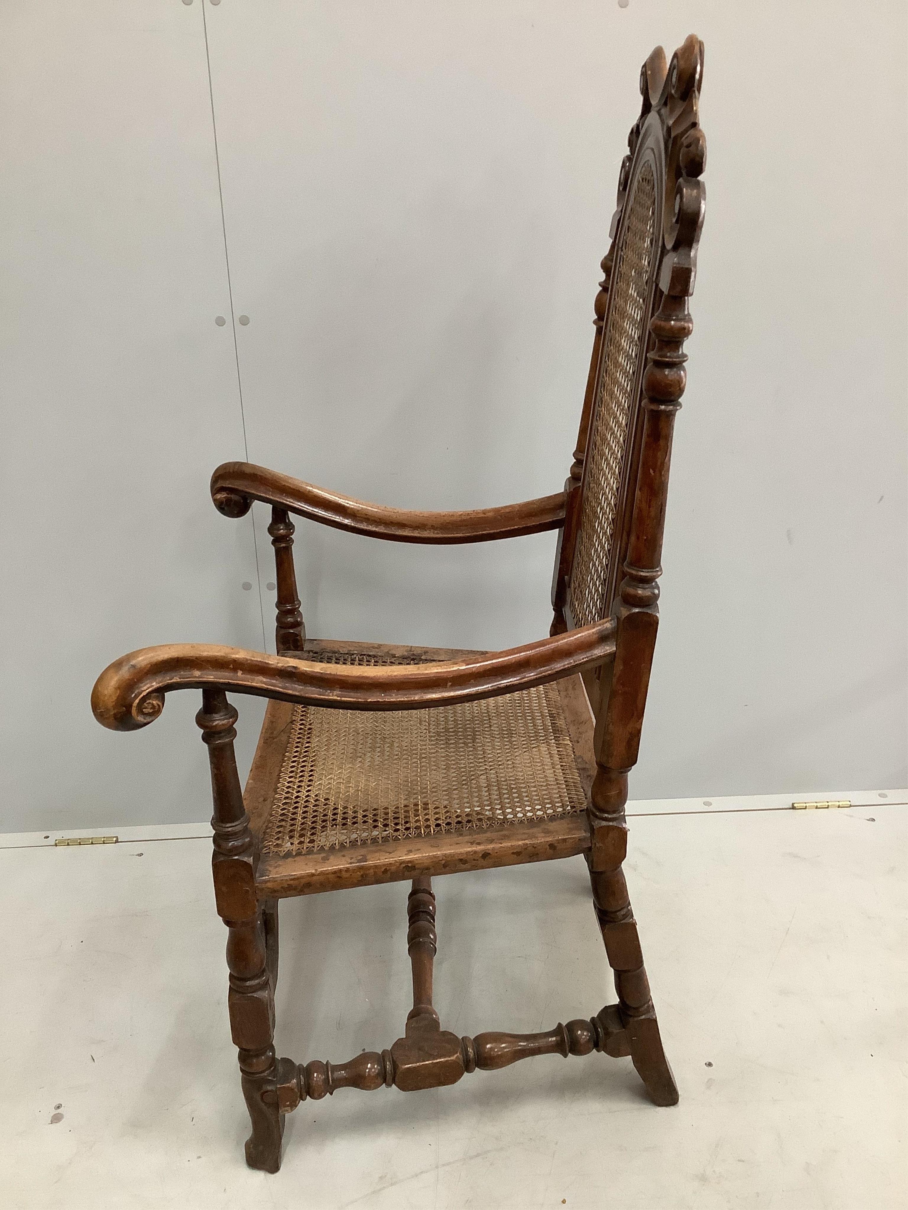 A William and Mary walnut and beech armchair, with a patera carved crest rail, and square and scroll twist legs, united by stretchers, width 66cm, depth 56cm, height 124cm. Condition - fair